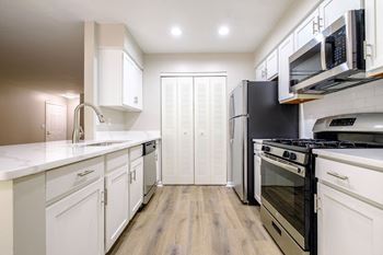 Stunning new kitchens with custom white cabinetry and gleaming granite countertops*
